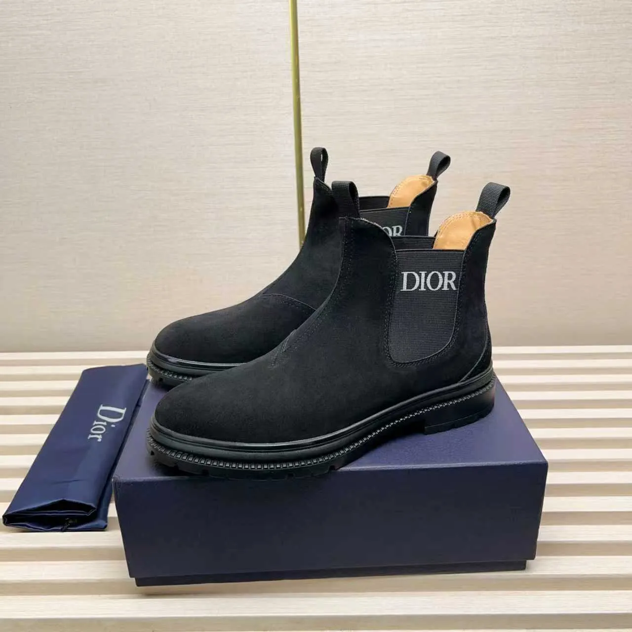 Men's Shoes 💰480 Dior A practical choice that combines protection with classic style. Made from durable Rugged Calf leather, it's tumbled and hand-finished to create a soft suede feel with a rich texture. Elastic side panels and subtle cutouts are inspired by the classic Chelsea boot. Leather upper and lining with Kummel tabs at front and rear, rubber outsole